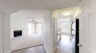 Located at 2207 Wickersham Lane in Austin, TX, this single-story 2-bedroom, 2-bathroom home offers a well-designed layout that balances comfort and functionality. The open-concept living room is bright and welcoming, featuring plush carpeting, a ceiling fan, and a classic tiled fireplace that serves as a natural focal point. Natural light filters in through windows overlooking the outdoor deck, enhancing the airy ambiance of the space. The kitchen is thoughtfully appointed with white cabinetry, gray tile backsplash, wood-look flooring, stainless steel appliances, and a peninsula with a light stone countertop — connecting seamlessly to the living area. The spacious primary bedroom includes carpet flooring, a ceiling fan, a window with outdoor views, and direct access to a dedicated bathroom and a walk-in closet outfitted with wire shelving. The second bedroom similarly features carpet flooring and a ceiling fan. Both bathrooms are clean and functional, each with a tub-shower combination and neutral finishes. A dedicated closet provides additional storage. The outdoor deck, visible from the living area, adds an inviting extension of the living space, ideal for relaxing or entertaining.