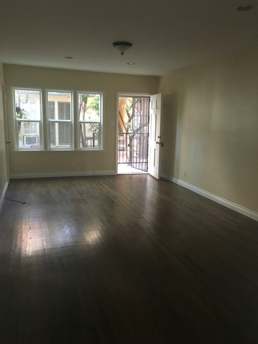 Spacious living room with real wooden floors - 1438 S Sherbourne Dr