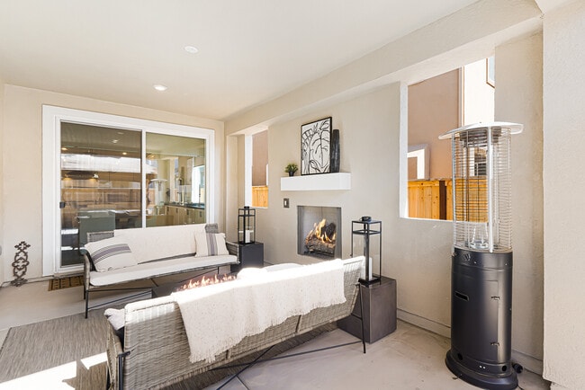 California room w/ fireplace, outdoor seating, fire pit, and decorations. - 5919 Lakestone Dr