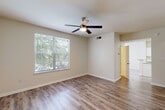 Located at 3505 Redwine Rd in East Point, Georgia, this three-bedroom, three-bathroom home is thoughtfully laid out across three floors, offering a functional and comfortable living experience. The ground floor features an attached garage with an automatic opener, providing convenient and secure parking or additional storage space. The main living level serves as the heart of the home, where a bright living room welcomes natural light through large windows and features wood-style laminate flooring and a ceiling fan. The adjacent kitchen is well-appointed with white cabinetry, a subway tile backsplash, granite countertops, stainless steel refrigerator, and a peninsula that opens toward the dining area — ideal for both cooking and entertaining. The upper floors house all three bedrooms, each finished with neutral tones and plush carpeting. The primary bedroom includes a closet, while additional bedrooms offer ample space and easy access to hallways and staircases. Each of the three bathrooms is well-equipped; one features a granite-topped vanity with white cabinetry and a tub-shower combination. Clean finishes, consistent neutral paint tones, and wood-style flooring in key areas lend a cohesive, move-in-ready aesthetic throughout the entire home.