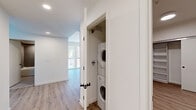 Located at 988 S Manhattan Pl in Los Angeles, CA, this modern 3-bedroom, 2-bathroom unit offers a well-designed single-floor layout with clean, contemporary finishes throughout. Light wood-look flooring flows seamlessly across the living areas and bedrooms, complementing the crisp white walls and creating a bright, cohesive aesthetic.

The open living area connects to a kitchen outfitted with light wood cabinetry, a stainless steel dishwasher, and a full-size refrigerator, offering a functional and stylish space for everyday living. Large windows in the living and bedroom areas invite generous natural light and provide views of the surrounding Los Angeles neighborhood.

Each of the three bedrooms is thoughtfully appointed, with the primary bedroom offering a comfortable footprint. Bedrooms feature sliding closet doors with built-in shelving, and the unit includes a total of five closets for ample storage. Both bathrooms are finished with large-format tile flooring, light wood vanities, and tub-shower combinations accented by gray stacked tile surrounds.

A dedicated in-unit laundry closet houses a stacked washer and dryer, adding everyday convenience. The unit also includes a balcony, ideal for outdoor relaxation. Recessed lighting and modern hardware complete the polished, move-in-ready feel of this Los Angeles residence.