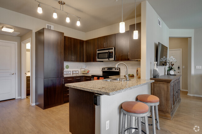 Kitchens feature sleek stainless steel appliance package, USB ports, and a built in pantry. - Liv Avenida