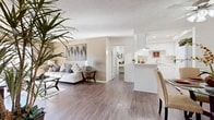 Located at 175 S Rio Vista St in Anaheim, California, this single-story residence offers two bedrooms, four bathrooms, a living room, and a kitchen across a thoughtfully designed floor plan. The open-concept living area features wood-style laminate flooring and a textured ceiling, creating a cohesive and inviting atmosphere. A sliding glass door brings in natural light and provides outdoor access, while a wall-mounted accent adds a decorative focal point. The kitchen is outfitted with white cabinetry, light countertops, a gas range, a full-size refrigerator, and a double sink, all complemented by the same wood-style flooring that carries throughout the main living spaces. The bedrooms are carpeted for comfort and each includes a ceiling fan, natural light from windows, and ample closet space. The primary bedroom is generously sized, offering a comfortable and functional retreat. The bathrooms feature clean white finishes with extended vanity countertops and matching cabinetry. Two hallways connect the rooms efficiently, supporting smooth traffic flow throughout the home. The overall design presents a neutral, well-maintained aesthetic with consistent finishes across all rooms, making this Anaheim residence a practical and comfortable living space.