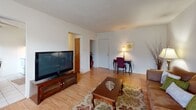 Located at 2049 Brown Ave in Bensalem, PA, this single-floor residence offers a thoughtfully arranged layout comprising a living room, dining room, bedroom, bathroom, and hallway. The living room is a welcoming, generously sized space featuring light hardwood-style flooring, a textured ceiling, large windows with decorative curtains that invite natural light, and a wall-mounted air conditioning unit. The open feel of the room makes it well-suited for both relaxing and entertaining. The dining area is positioned adjacent to the kitchen and benefits from its own window with outdoor views, tile flooring, and a ceiling fan, creating a bright and casual setting for meals. The bedroom is a spacious retreat with hardwood-style flooring, a large window providing natural light and exterior views, and a closet with a warm wood-toned door. The textured ceiling continues throughout, lending a consistent character to the home. The bathroom is finished with neutral tile work extending from the floor up the walls of the tub-shower combination, complemented by a classic white soaking tub. The hallway connects the rooms efficiently, completing this compact yet functional single-story home.