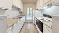 This single-story, 1-bedroom, 2-bathroom residence offers a practical and comfortable layout across a compact but efficiently organized floor plan. The open-concept living, dining, and kitchen area forms the heart of the home, with the spacious carpeted living room serving as a welcoming focal point, highlighted by a classic white-mantled fireplace and a textured ceiling. Natural light filters in through a window overlooking greenery, creating a bright and inviting atmosphere.

The galley-style kitchen is well-equipped with white cabinetry, granite-style countertops, light hardwood-style flooring, a full suite of appliances including an electric range, dishwasher, and refrigerator, and a window that brings in additional natural light. A ceiling fan overhead adds comfort to the adjoining dining area.

The bedroom is generously sized with plush carpeting, a large closet with built-in shelving, a window with outdoor views, and a textured ceiling. Two bathrooms serve the unit, one featuring a full tub-shower combination with wood-style flooring. Three closets throughout the home provide notable storage flexibility, rounding out this thoughtfully designed and functional living space.