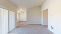 Located at 4665 Campbell Dr SE in Salem, Oregon, this single-floor, three-bedroom, one-bathroom home offers a practical and comfortable layout. The interior is finished with neutral tones throughout, creating a bright and clean atmosphere. Common areas and the kitchen feature durable luxury vinyl plank flooring, while the bedrooms are carpeted for added comfort.

The galley-style kitchen is well-equipped with white cabinetry, ample upper and lower storage, a built-in range, refrigerator, and a sink with countertop workspace on both sides. A ceiling fan provides ventilation and natural light flows in through a window at the end of the kitchen. Adjacent to the kitchen is a dedicated laundry area with washer and dryer hookups, cabinetry, and a shelving unit for additional storage.

The spacious primary bedroom features vaulted ceilings, a walk-in closet, and a secondary door providing added flexibility. The additional bedrooms are well-proportioned, each carpeted and featuring closets with built-in shelving. Natural light filters into the secondary bedrooms through windows with outdoor tree views. A central hallway connects all rooms, ensuring a functional flow throughout the home. Ceiling fans are present in the living and kitchen areas, adding to the home's practical, everyday comfort.