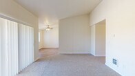 Located at 4665 Campbell Dr SE in Salem, Oregon, this single-floor, three-bedroom, one-bathroom home offers a practical and comfortable layout. The interior is finished with neutral tones throughout, creating a bright and clean atmosphere. Common areas and the kitchen feature durable luxury vinyl plank flooring, while the bedrooms are carpeted for added comfort.

The galley-style kitchen is well-equipped with white cabinetry, ample upper and lower storage, a built-in range, refrigerator, and a sink with countertop workspace on both sides. A ceiling fan provides ventilation and natural light flows in through a window at the end of the kitchen. Adjacent to the kitchen is a dedicated laundry area with washer and dryer hookups, cabinetry, and a shelving unit for additional storage.

The spacious primary bedroom features vaulted ceilings, a walk-in closet, and a secondary door providing added flexibility. The additional bedrooms are well-proportioned, each carpeted and featuring closets with built-in shelving. Natural light filters into the secondary bedrooms through windows with outdoor tree views. A central hallway connects all rooms, ensuring a functional flow throughout the home. Ceiling fans are present in the living and kitchen areas, adding to the home's practical, everyday comfort.