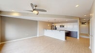 Located in Canton, Ohio, this well-appointed 2-bedroom, 2-bathroom residence offers a thoughtfully designed single-floor layout with modern finishes throughout. The open-concept living and kitchen area serves as the heart of the home, featuring light hardwood-style flooring, recessed lighting, and a ceiling fan. The kitchen is equipped with stainless steel appliances — including a refrigerator, range, and built-in microwave — complemented by rich dark cabinetry, granite countertops with undermount lighting, a subway tile backsplash, and a peninsula with pendant lighting that provides additional seating and workspace.

The living area is generously sized and bathed in natural light, opening to a wall of large windows that frame impressive panoramic views of the Canton skyline — a standout feature of this residence. Both bedrooms are carpeted and offer ample storage, including double-door closets. The primary bedroom is notably spacious, with its own window overlooking the city.

The primary bathroom features a dual-sink vanity with granite countertops, dark wood cabinetry, a large mirror, and a walk-in shower. A hallway connects all rooms, maintaining a clean and functional flow. The neutral color palette and contemporary design elements create a cohesive, move-in-ready atmosphere throughout.