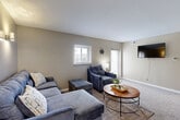 Located at 9514 N Avenue Plaza in Omaha, Nebraska, this thoughtfully laid-out one-bedroom, two-bathroom residence offers a comfortable and functional living experience across a single floor. The living room serves as the heart of the home, featuring warm neutral-toned walls, soft carpeting, wall-mounted sconce lighting, and multiple windows that invite natural light throughout the day. The space accommodates a generous seating arrangement and a wall-mounted television, making it ideal for both relaxing and entertaining.

The kitchen is a standout feature, showcasing rich warm wood cabinetry, a stylish mosaic tile backsplash, and a full suite of stainless steel appliances including a refrigerator, dishwasher, and range. Light wood-look vinyl flooring and a skylight add brightness and a modern touch to this well-equipped cooking space.

The bedroom is a peaceful retreat with plush carpeting, a ceiling fan with light fixture, a mirrored sliding-door closet, and a window offering natural light. The two bathrooms are clean and well-appointed, one featuring a tub-shower combination with elegant marble-style tile surround, vinyl flooring, and a window for ventilation. Warm beige tones and consistent finishes throughout create a cohesive and inviting ambiance.