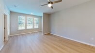 Located along SW 24th Ave in Gainesville, FL, this 1-bedroom, 1-bathroom residence offers a thoughtfully designed layout with contemporary finishes throughout. Light hardwood-style flooring runs continuously across the entire floor plan, creating a cohesive and airy feel.

The open-concept kitchen and living area serves as the heart of the home. The kitchen is outfitted with stainless steel appliances, including a refrigerator, electric range, microwave, and dishwasher. A two-tone cabinetry design pairs warm wood lower cabinets with crisp white uppers, accented by a subtle tile backsplash and clean white countertops. A central island with a white countertop provides additional prep space and casual seating. Pendant lighting adds a modern touch overhead.

The living area is generously proportioned, featuring multiple windows that invite abundant natural light and views of the surrounding greenery. A ceiling fan provides comfort and airflow throughout the space.

The bedroom is a comfortable, well-lit retreat with windows overlooking a private balcony. A dedicated closet offers organized storage, and the room connects conveniently to the rest of the unit.

The bathroom is finished with large-format tile surrounding a full soaking tub and shower combination, complemented by brushed nickel fixtures for a clean, modern aesthetic.