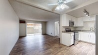 This 670 square foot apartment offers a thoughtfully designed living space with two bedrooms and one bathroom. The interior boasts a modern aesthetic with newly installed wood-look flooring throughout, creating a cohesive and contemporary ambiance. The primary bedroom, measuring 130 square feet, provides a comfortable retreat.

The apartment's open-concept living area seamlessly integrates the kitchen and living room, maximizing the use of space. Large windows in various rooms allow for abundant natural light, enhancing the sense of openness. The kitchen features sleek white cabinetry, granite-look countertops, and stainless steel appliances, including a built-in microwave.

Mirrored closet doors in the bedrooms not only provide ample storage but also create an illusion of additional space. The bathroom, though compact, is efficiently designed with a single vanity and modern fixtures. Textured ceilings throughout add a subtle decorative element to the space.

The apartment's neutral color palette, predominantly in shades of white and beige, offers a blank canvas for personal decorating styles. Overall, this single-floor dwelling presents a well-planned layout that maximizes functionality in a modest footprint, ideal for those seeking a contemporary living space in a compact setting.