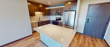 This contemporary 860 square foot apartment in Madison, WI offers a well-designed living space with two bedrooms and two bathrooms. The open floor plan maximizes the use of space, creating a seamless flow between the living areas. Large windows and a private balcony flood the interior with natural light and provide stunning city views.

The kitchen is a highlight, featuring modern wood cabinetry, stainless steel appliances, and a spacious island with quartz countertops. The living area is perfect for relaxation or entertaining, with ample room for furniture arrangements.

Both bedrooms are generously sized, with the primary bedroom measuring 160 square feet. The bathrooms are sleek and functional, with modern fixtures and ample storage. Throughout the apartment, you'll find high-quality finishes, including wood-look flooring and recessed lighting.

Additional features include a ceiling fan for comfort, in-unit laundry, and a closet for extra storage. The apartment's single-floor layout and thoughtful design make it an ideal choice for those seeking a modern, low-maintenance living space in the heart of Madison.