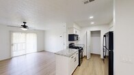 Located at 6611 Seahurst Dr in Columbus, OH, this 2-bedroom, 2-bathroom single-floor residence offers a bright and efficiently designed living space. The open-concept kitchen and living area form the heart of the home, featuring white shaker-style cabinetry, granite-patterned countertops, a peninsula island, and a full suite of black appliances including a gas range, over-the-range microwave, dishwasher, and refrigerator. Recessed lighting and a textured ceiling add depth to the kitchen area, while light hardwood-style flooring flows seamlessly throughout the entire home. The living area is generously sized, with a ceiling fan providing added comfort and vertical blinds offering light control. Both bedrooms are well-proportioned, each equipped with ceiling fans and windows that bring in natural light. The primary bedroom is notably spacious and includes closet storage. Three closets in total provide ample storage throughout the home. The two bathrooms are finished in a clean, minimal style with light flooring, a framed mirror, black fixtures, and a tub-shower combination. The overall aesthetic is fresh and contemporary, with a crisp white palette and modern finishes creating a cohesive and move-in-ready environment.