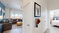 Located at Cleburne Station in Cleburne, TX, this single-story 2-bedroom, 3-bathroom residence offers a well-designed layout with modern finishes throughout. The welcoming entrance opens into a bright, open-concept living and dining area featuring soaring ceilings, light wood-look flooring, and a bold accent wall that adds character to the space. Natural light flows freely through large windows, enhancing the airy atmosphere. The kitchen is outfitted with white shaker cabinetry, granite countertops, stainless steel appliances, and a functional peninsula, making it both practical and visually appealing. A sliding glass door leads directly to a private patio, providing seamless indoor-outdoor living. The spacious primary bedroom connects to its own bathroom and benefits from elevated ceilings, creating a relaxing retreat. The second bedroom is well-proportioned, featuring multiple windows with neighborhood views. All three bathrooms are finished with granite-topped white vanities and wood-look flooring, maintaining a cohesive, clean aesthetic. Additional highlights include four closets, a dedicated laundry area, and a hallway that efficiently connects all areas of the home. The unit combines functionality with contemporary style throughout.