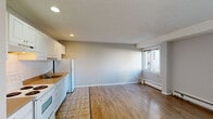 Located at 630 17th Ave SW in Calgary's vibrant 17th Avenue corridor, this one-bedroom, one-bathroom unit offers a practical and well-organized layout across a single floor. The space is finished with hardwood-style laminate flooring throughout the main living areas, providing a cohesive and clean aesthetic.

The kitchen is efficiently designed, featuring white shaker-style cabinetry with ample upper and lower storage, a white tile backsplash, warm laminate countertops, and white appliances including a fridge, stove, and dishwasher. Tile flooring in the kitchen area transitions seamlessly into the laminate of the adjoining living space. Recessed lighting keeps the kitchen bright and functional.

The bedroom offers a comfortable footprint, highlighted by a large sliding-door closet, a window with street views, and baseboard heating. Neutral grey walls and a textured ceiling contribute to a calm, understated atmosphere.

The bathroom is well-appointed with a full-width vanity, a large mirror, a tiled tub-and-shower combination, and tile flooring. The living area provides an open, flexible space with neutral walls and laminate flooring, suitable for a variety of furniture arrangements. Overall, the unit presents a clean, move-in ready interior with functional finishes throughout.