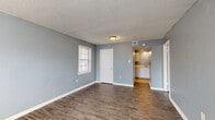 This single-story home in Memphis, Tennessee offers a practical and functional layout with three bedrooms and one full bathroom. Throughout the living spaces, durable wood-look flooring flows consistently, complemented by cool blue-gray painted walls and white baseboards that create a clean, cohesive aesthetic. Textured ceilings add a classic touch across the home.

The generously sized primary bedroom is the largest of the three rooms, featuring two windows that invite ample natural light and connect the space to the outdoors. The additional bedrooms are well-proportioned, each with their own window for natural light, and one includes a built-in closet with a hanging rod for convenient storage.

The kitchen is equipped with white cabinetry, light-toned countertops, a stainless steel sink, and ample upper and lower cabinet storage. The layout provides a functional workspace suitable for everyday use.

The full bathroom features a combination tub and shower with a white surround, classic tile wainscoting in a neutral tone, a vanity with white cabinetry, and wood-look flooring that ties into the rest of the home.

Overall, this home presents a straightforward and move-in ready layout with consistent finishes throughout, offering a comfortable and practical living environment in Memphis, TN.