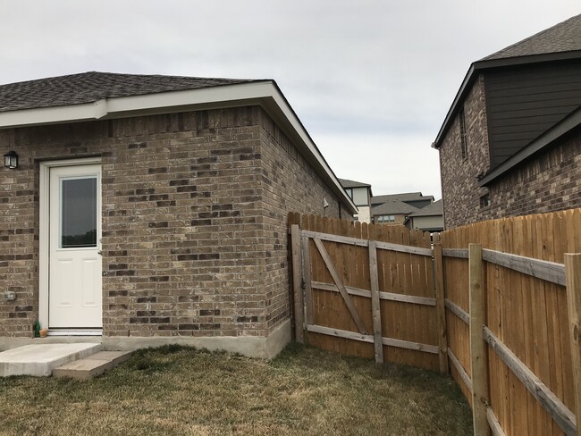 The back of the house with the privacy fence and entrance gate - 1313 Eagle Ridge Trl