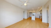 Located in Miami, FL, this well-appointed 2-bedroom, 2-bathroom residence offers a clean, modern aesthetic throughout its single-floor layout. Light wood-look flooring flows seamlessly across the open-concept living and dining area, which is anchored by a ceiling fan and filled with natural light from large windows and a glass balcony door offering open exterior views. The contemporary kitchen is a standout, featuring white flat-panel cabinetry, open shelving, stainless steel appliances including a range, microwave, and dishwasher, a undermount sink, and a central island with a white quartz countertop — ideal for both cooking and casual dining. The spacious primary bedroom offers generous proportions, a walk-in closet with wire shelving, and an en-suite bathroom with a glass-enclosed walk-in shower. The second bedroom is bright and comfortable, with large windows framing outdoor views and access to a full bathroom equipped with a soaking tub and a well-sized vanity with storage. Both bedrooms include dedicated closets. Additional highlights include a utility room, in-unit laundry, and a private balcony, rounding out a highly functional and modern living space.