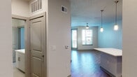 This single-floor residence offers a well-designed open-concept layout that seamlessly connects the kitchen, dining, and living areas. The kitchen is a standout feature, equipped with sleek grey flat-front cabinetry, white countertops, stainless steel appliances including a refrigerator with ice maker, electric range, built-in microwave, and dishwasher. A central kitchen island with pendant lighting above provides additional prep space and a natural gathering point. The living area is finished with rich hardwood-style flooring, a ceiling fan with light, and large windows with horizontal blinds that invite natural light and provide views of the outdoor balcony. The bedroom is carpeted for comfort and includes access to a walk-in closet with built-in shelving and rod space. The bathroom is finished with tile flooring, a sliding glass-door walk-in shower with large-format tile surround, a vanity with sink, and standard fixtures. Neutral tones throughout the space, including soft grey and white walls, create a clean, cohesive aesthetic. The textured ceiling and recessed lighting add to the polished, contemporary feel of this thoughtfully laid-out single-level residence.