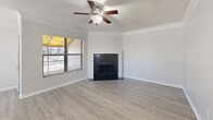 Located in Clearwater, FL, this 2-bedroom, 2-bathroom single-floor residence offers a well-organized layout encompassing a living room, dining room, kitchen, hallway, and closet. The living room is a welcoming centerpiece, featuring a bold black-tiled wood-burning fireplace, crown molding, a ceiling fan, and light wood-look flooring that extends through the common areas. Natural light filters in through blinds-covered windows, with views of surrounding greenery. The kitchen is outfitted with dark cabinetry, light countertops, stainless steel appliances including a refrigerator and microwave, a dishwasher, and an electric range, all set on matching wood-look flooring. Both bedrooms are carpeted and include ceiling fans; the second bedroom features corner windows on two walls, filling the room with ample natural light. The primary bedroom offers a spacious bi-fold door closet and direct hallway access. Each bathroom is cleanly finished, with one featuring a tub/shower combo and the other a dark-cabinet vanity with light countertop. A screened porch with a canopied ceiling provides a comfortable outdoor retreat with views of mature trees and the surrounding landscape.
