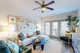 Located at 349 Decatur St SE in Atlanta's vibrant Grant Park neighborhood, this single-floor 2-bedroom, 1-bathroom residence offers a thoughtfully designed open-concept layout with a warm, modern aesthetic. The kitchen is a standout feature, equipped with rich dark wood cabinetry, granite countertops, stainless steel appliances, a tiled backsplash, and a peninsula with bar seating — perfect for casual dining. A walk-in pantry provides excellent storage. The kitchen flows seamlessly into the living area, which is brightened by natural light streaming through French doors that open to an outdoor balcony. Ceiling fans add comfort throughout. The primary bedroom is generously proportioned, with plush carpet flooring, ample closet space, and large windows. The second bedroom is equally comfortable, featuring soft carpet and good natural light. A light-filled hallway connects the bedrooms and full bathroom, which is accented with tile flooring. The in-unit laundry room houses a stacked washer and dryer for added convenience. Throughout the residence, hardwood-style flooring anchors the main living spaces, while neutral tones and clean lines create a bright, inviting atmosphere well-suited to urban living in Atlanta.