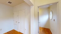 Located at 2412 Ellsworth St in Berkeley, CA, this single-floor, 3-bedroom, 1-bathroom unit offers a well-organized layout across a comfortable footprint. Warm hardwood flooring flows throughout the living areas, hallway, and all three bedrooms, lending the space a cohesive and inviting character. The living room is bright and airy, featuring a glass door with sheer curtains that opens to a balcony, allowing natural light to pour in and providing pleasant outdoor views. Crown molding adds a refined touch throughout the common areas. The kitchen is fitted with cream cabinetry, dark countertops, a stainless steel sink, and large windows that frame lush greenery outside, creating a light-filled and functional cooking space. Light tile flooring completes the kitchen's clean aesthetic. The three bedrooms are well-proportioned, with the primary bedroom offering built-in closet space and hardwood floors. The additional bedrooms are bright and versatile. The shared bathroom features classic pink wall tile, a shower-tub combo with a decorative curtain, a white vanity with a stone-top sink, and a window for natural ventilation. A central hallway connects all rooms efficiently, complemented by a welcoming entrance. This unit offers practical, comfortable living in a prime Berkeley location.