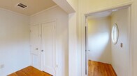 Located at 2412 Ellsworth St in Berkeley, CA, this single-floor, 3-bedroom, 1-bathroom unit offers a well-organized layout across a comfortable footprint. Warm hardwood flooring flows throughout the living areas, hallway, and all three bedrooms, lending the space a cohesive and inviting character. The living room is bright and airy, featuring a glass door with sheer curtains that opens to a balcony, allowing natural light to pour in and providing pleasant outdoor views. Crown molding adds a refined touch throughout the common areas. The kitchen is fitted with cream cabinetry, dark countertops, a stainless steel sink, and large windows that frame lush greenery outside, creating a light-filled and functional cooking space. Light tile flooring completes the kitchen's clean aesthetic. The three bedrooms are well-proportioned, with the primary bedroom offering built-in closet space and hardwood floors. The additional bedrooms are bright and versatile. The shared bathroom features classic pink wall tile, a shower-tub combo with a decorative curtain, a white vanity with a stone-top sink, and a window for natural ventilation. A central hallway connects all rooms efficiently, complemented by a welcoming entrance. This unit offers practical, comfortable living in a prime Berkeley location.