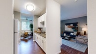 Located at 24080 Amador St in Hayward, CA, this single-floor, 2-bedroom, 2-bathroom home offers a thoughtfully designed layout that maximizes functionality and comfort. The open-concept living area features rich wood-style flooring and flows effortlessly into the dining space, which is brightened by natural light from large windows and accented by a ceiling fan overhead. The kitchen is positioned centrally, featuring white cabinetry with sleek hardware, stone-toned countertops, a stainless steel sink, and a dishwasher — all oriented to maintain visual connection with both the living and dining areas. The living room provides a comfortable retreat with neutral walls and ample space for relaxing. Both bathrooms are finished with clean white tile surrounds, tub-shower combinations, wide vanity mirrors, and warm countertops. The secondary bedroom is carpeted and filled with natural light from a large window, offering a built-in closet with wire shelving for organized storage. The spacious primary bedroom similarly features plush carpeting and generous closet space. Together, the rooms create a cohesive, livable home with a clean, contemporary aesthetic suited for everyday comfort.