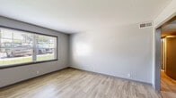 Located at 4960 Edmondson Pike in Nashville, TN, this 2-bedroom, 1-bathroom unit offers a well-designed single-level layout with contemporary updates throughout. The kitchen is a standout feature, showcasing granite countertops, gray shaker-style cabinetry, stainless steel appliances including a range, over-the-range microwave, and dishwasher, all complemented by light wood-style flooring. A dedicated laundry closet with washer/dryer hookups adds everyday convenience directly off the kitchen. The primary bedroom is generously sized, featuring the same light wood-style flooring, neutral gray walls, and a large window that fills the room with natural light and outdoor views. The second bedroom offers plush carpeting, a window with exterior views, and a clean, neutral palette. The bathroom continues the granite theme with a matching vanity countertop, dark cabinetry, a wall-mounted mirror, wood-style tile flooring, and a tiled shower with grab bars. A hallway and closet round out the functional layout. Throughout the unit, consistent neutral tones, updated finishes, and practical design choices create a cohesive and move-in-ready living environment.