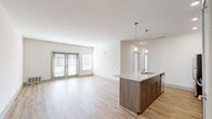 Located at 14240 White Creek Ave NE in Cedar Springs, MI, this well-appointed single-story home offers three bedrooms and two bathrooms within a thoughtfully designed floor plan. The open-concept kitchen and living area serves as the heart of the home, showcasing warm, medium-tone cabinetry, granite countertops, a kitchen island with an integrated sink, and a full suite of stainless steel appliances including a refrigerator, range, and microwave. Recessed lighting and a pendant light above the island add a modern touch, while light hardwood-style flooring extends throughout the main living areas. The three bedrooms are carpeted for comfort, with each room featuring neutral walls, natural light from windows with blinds, and ceiling vents for climate control. The primary bedroom includes a dedicated walk-in closet with wire shelving for organized storage. The two bathrooms are finished with clean white fixtures — one featuring a walk-in shower with a chrome fixture and grab bar, and the other a full soaking tub and shower combination. A dedicated laundry room houses a full-size washer and dryer with overhead shelving. The consistent use of light tones and hardwood-style flooring throughout creates a bright, cohesive, and move-in-ready living environment.