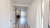 Located at 6380 Denton Way in Citrus Heights, CA, this single-floor 2-bedroom, 1-bathroom residence offers a thoughtfully updated interior with a clean, modern aesthetic. The living area serves as the heart of the home, anchored by a tile-surround fireplace set against a contrasting gray accent wall with recessed lighting above, creating a warm and inviting focal point. Natural light filters through windows, complementing the light-toned wood-style flooring that runs consistently throughout the unit.

The kitchen is well-appointed with granite countertops, gray cabinetry, a peninsula for additional prep or dining space, and white appliances. A recessed ceiling fixture provides ample overhead illumination, adding to the functional design.

Both bedrooms are comfortably sized with large windows that invite natural light. One bedroom features a sliding barn-style closet, while another includes a standard double sliding-door closet, offering practical storage solutions. A ceiling fan is also present in one of the bedrooms.

The bathroom showcases granite countertops atop stylish cabinetry with a well-lit vanity mirror, maintaining the cohesive design language found throughout. The hallway connecting the rooms is bright and open. Textured ceilings and consistent wood-style flooring tie the entire unit together seamlessly.