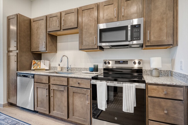 Modern kitchen featuring sleek cabinetry, contemporary finishes, and ample storage at Mesquite Trail - Mesquite Trails at Brooks - A 55+ Community