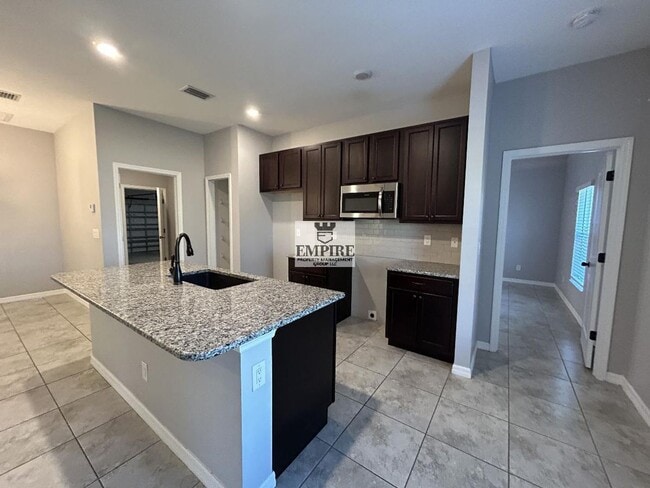 Building Photo - COMING SOON! 3 Beds + Den, 2 Baths, Screened Lanai & More!