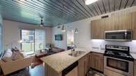 Located in Houston's 77004 zip code, this thoughtfully designed 1-bedroom, 1-bathroom unit blends modern finishes with industrial-inspired character. The defining architectural feature throughout is the striking dark wood plank ceiling, which adds warmth and texture while exposed conduit in the bedroom lends an urban loft aesthetic.

The open-concept kitchen flows seamlessly into the living area and is outfitted with warm wood cabinetry, granite countertops, a subway tile backsplash, stainless steel appliances — including a range, microwave, and refrigerator — and a kitchen island with pendant lighting and bar seating. Polished concrete flooring grounds the living and kitchen spaces with an industrial edge.

The living room is bright and inviting, featuring a sliding glass door that opens to a private balcony with outdoor views, allowing natural light to fill the space. A ceiling fan adds comfort overhead.

The bedroom is a calm retreat, featuring carpet flooring, a ceiling fan, and a large window that brings in additional natural light. The bathroom is sleek and efficiently designed, with granite countertops, wood-tone cabinetry, light tile flooring, and a walk-in glass-enclosed shower. Every detail in this unit reflects a cohesive, contemporary design sensibility.