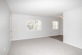Located at 744 Eayrestown Rd in Lumberton, NJ, this single-floor, two-bedroom, one-bathroom unit offers a practical and well-organized layout. The open living area features light-toned flooring and connects seamlessly to the kitchen, which is outfitted with white shaker-style cabinetry, stone-look countertops, and a full suite of stainless steel appliances including a refrigerator, electric range, and microwave. A ceiling-mounted light fixture keeps the kitchen well-lit throughout the day.

Both bedrooms are carpeted and painted in soft, neutral tones, creating a calm and comfortable atmosphere. The spacious primary bedroom offers generous floor space and benefits from multiple windows that invite natural light and views of surrounding greenery. The second bedroom is similarly appointed, featuring its own window and closet access. Both rooms include built-in closets for ample storage.

The full bathroom is finished with wood-look vinyl flooring, a white soaking tub with a curved shower rod and tub surround, and brushed gold hardware accents that add a modern touch. A small window provides natural ventilation. Clean white walls and neutral finishes throughout the unit create a cohesive, move-in-ready aesthetic well suited for comfortable everyday living.