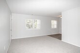 Located at 744 Eayrestown Rd in Lumberton, NJ, this single-floor, two-bedroom, one-bathroom unit offers a practical and well-organized layout. The open living area features light-toned flooring and connects seamlessly to the kitchen, which is outfitted with white shaker-style cabinetry, stone-look countertops, and a full suite of stainless steel appliances including a refrigerator, electric range, and microwave. A ceiling-mounted light fixture keeps the kitchen well-lit throughout the day.

Both bedrooms are carpeted and painted in soft, neutral tones, creating a calm and comfortable atmosphere. The spacious primary bedroom offers generous floor space and benefits from multiple windows that invite natural light and views of surrounding greenery. The second bedroom is similarly appointed, featuring its own window and closet access. Both rooms include built-in closets for ample storage.

The full bathroom is finished with wood-look vinyl flooring, a white soaking tub with a curved shower rod and tub surround, and brushed gold hardware accents that add a modern touch. A small window provides natural ventilation. Clean white walls and neutral finishes throughout the unit create a cohesive, move-in-ready aesthetic well suited for comfortable everyday living.