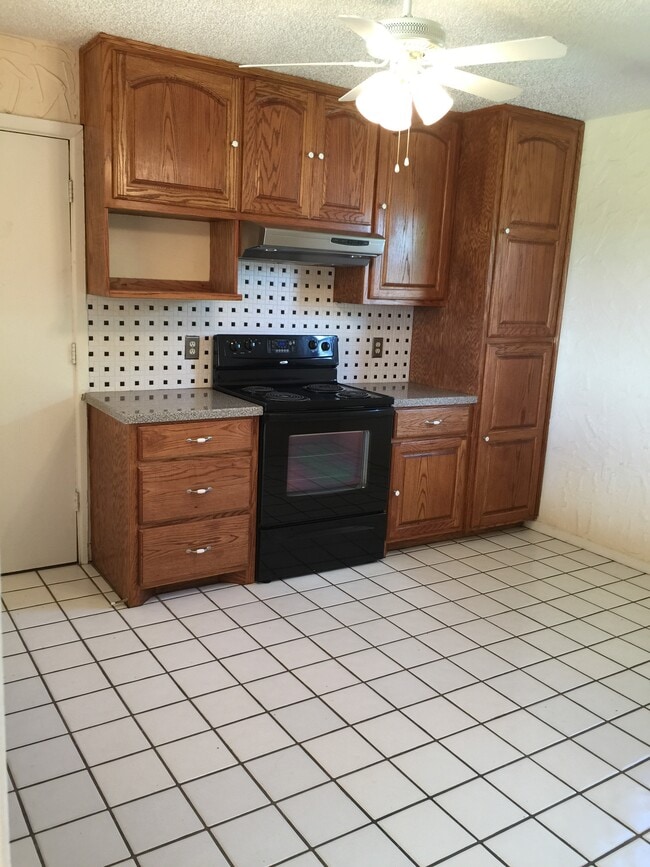 Kitchen with stove and storage - 4123 Villa Dr
