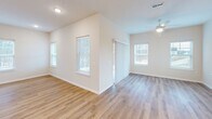 Located at 1352 Town Square Dr in Kent, Ohio, this well-appointed single-floor home offers 2 bedrooms and 2 bathrooms within a thoughtfully designed layout. The heart of the home is an expansive open-concept living, dining, and kitchen area bathed in natural light from large windows. The kitchen showcases white shaker cabinetry, a classic subway tile backsplash, a central island with a sink, pendant lighting, and a full suite of stainless steel appliances including a gas range, microwave, and French door refrigerator. Warm-toned luxury vinyl plank flooring flows throughout the main living areas, creating a cohesive and clean aesthetic. The generously sized primary bedroom features soft carpeting, multiple windows with natural light, and access to a private en-suite bathroom equipped with a dual-sink vanity and a glass-enclosed shower. A spacious walk-in closet with extensive wire shelving provides ample storage. The second bedroom is equally comfortable with plush carpet and a bright window. The second full bathroom includes a tub-shower combo and a white vanity. Additional highlights include multiple closets, a dedicated laundry room, pantry, utility room, and a hallway connecting the layout efficiently.