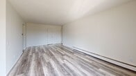 Located in White Bear Lake, Minnesota, this two-bedroom, one-bathroom unit offers a well-organized single-floor layout spanning a comfortable living area. The open-concept living, dining, and kitchen zone serves as the heart of the home, featuring modern light gray luxury vinyl plank flooring, a textured ceiling, and baseboard heating. A sliding glass door opens directly onto a private balcony, flooding the living space with natural light and providing outdoor views of the surrounding neighborhood and trees.

The kitchen is efficiently positioned adjacent to the living and dining areas, with white cabinetry and a white range, maintaining a clean and cohesive aesthetic throughout the common areas.

Both bedrooms are carpeted and bright, each featuring louvered bi-fold closet doors that provide generous storage. The primary bedroom is notably spacious and includes dual windows that bring in ample natural light, along with an extended wall of closet space. The second bedroom also features a closet and a sun-filled window.

The bathroom is finished with classic white subway-style wall tile, mosaic tile flooring, a wide vanity with under-sink cabinetry, and a large mirror with overhead lighting. Four total closets throughout the unit ensure plentiful storage. The unit presents a clean, neutral palette throughout.