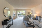 Located at 1050 Summerside Dr in San Jose, CA, this single-floor residence offers a thoughtfully laid-out 1-bedroom, 1-bathroom floor plan with a comfortable range of living spaces. The living room is generously sized, featuring plush carpeting, neutral toned walls, a textured ceiling, and large sliding glass doors that invite natural light and open directly onto a private patio with outdoor greenery views. Adjacent to the living room, the dining area provides a seamless transition for everyday living and entertaining. The galley-style kitchen is efficiently designed with warm wood cabinetry extending to the ceiling, laminate countertops, hardwood-style flooring, and white appliances including a range and refrigerator. A hallway connects the main living areas to the private bedroom, which is a well-proportioned retreat with a large window, plush carpet, and a reach-in closet. A second closet provides additional storage. The bathroom features hardwood-style flooring, a single-sink vanity with wood cabinetry, and a shower-tub combination. Throughout the residence, a consistent neutral color palette and textured ceilings create a cohesive, calm ambiance suited to comfortable everyday living.