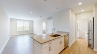 Located at 1330 Nashville Pike in Gallatin, Tennessee, this 2-bedroom, 1-bathroom residence offers a thoughtfully designed single-floor layout. The open-concept kitchen and living area serves as the heart of the home, featuring a peninsula with granite countertops and an undermount sink, crisp white cabinetry with brushed nickel hardware, and a full suite of stainless steel appliances including a refrigerator, electric range, and over-the-range microwave. Light hardwood-style flooring flows consistently throughout the entire unit, lending a clean and cohesive aesthetic.

Both bedrooms are well-proportioned, each offering natural light through windows with views of the surrounding landscape. The primary bedroom provides a comfortable footprint, while the second bedroom includes a ceiling fan. A dedicated closet provides convenient storage.

The bathroom is finished with the same attention to detail found throughout the unit, showcasing a granite-topped vanity with white cabinetry, a subway-tiled tub-shower combination, and recessed lighting. Neutral warm-toned walls and clean white trim create a bright, welcoming ambiance across all rooms, making this a move-in-ready residence in a convenient Gallatin location.