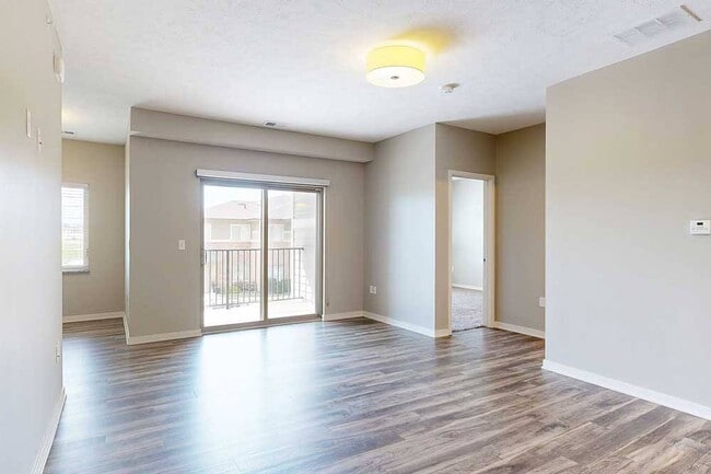 Step into bright, open-concept living with seamless access to your private balcony, perfect for relaxing or entertaining. - The Villas at Falling Waters