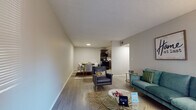 Located at 1400 Ventura Way Dr in Charlotte, NC, this single-floor residence offers a thoughtfully designed layout that balances comfort and functionality. The open-concept living and dining area serves as the heart of the home, featuring durable wood-look flooring, neutral gray walls, and a textured ceiling. Natural light filters through a large window, brightening the living space, which flows seamlessly into the dedicated dining area. The kitchen is equipped with dark cabinetry, a black electric range, and a double sink with ample counter space, making it both practical and efficient. Two well-sized bedrooms provide comfortable retreats, each featuring plush carpeting, windows that invite natural light, and generous closet space with built-in shelving. The primary bedroom offers views of the surrounding greenery. The residence includes two bathrooms: one with a shower/tub combination and dark cabinetry vanity, and a second featuring a single-sink vanity with warm wood-toned cabinetry. Throughout the home, consistent neutral tones and clean finishes create a cohesive, welcoming ambiance suited for everyday living in Charlotte's vibrant community.