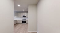 Located at 436 State Highway 30 in Port Wentworth, Georgia, this two-bedroom, two-bathroom single-floor residence offers a well-designed layout with modern finishes throughout. Wood-look flooring flows consistently across the home, complementing the neutral color palette and creating a cohesive, contemporary aesthetic.

The kitchen serves as a functional centerpiece, featuring shaker-style cabinetry in a soft gray-white tone, white countertops, a subway tile backsplash, and a full suite of stainless steel appliances including a refrigerator, electric range, over-the-range microwave, and dishwasher. A center island with a deep stainless sink and pendant lighting adds both workspace and visual interest, with an open sightline toward the living area.

The primary bedroom is a comfortable, well-proportioned space with dual windows that invite natural light and offer outdoor views of the surrounding greenery. It connects to a private en-suite bathroom featuring a dual-sink vanity with white countertops, a large framed mirror, and a separate walk-in shower. The second bedroom also benefits from natural light via a window with outdoor views and ceiling fan. A second full bathroom includes a tiled tub-shower combination with brushed nickel fixtures. Both bedrooms are served by closets equipped with wire shelving systems for organized storage.