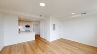 Located at 2140 North Lincoln Park West in Chicago's sought-after Lincoln Park neighborhood, this efficiently designed studio offers a clean, modern aesthetic with thoughtful finishes throughout. The open-plan kitchen and living area is anchored by light hardwood flooring that runs seamlessly across the entire space, lending a sense of warmth and continuity. The kitchen is well-appointed with custom light-toned cabinetry featuring black hardware, a quartz waterfall island, a white subway tile backsplash, stainless steel appliances including a built-in microwave and range, and a matte black faucet over the undermount sink. Recessed lighting throughout keeps the space bright and airy. The living area is bathed in natural light from a large picture window that frames sweeping views of Lake Michigan and Lincoln Park's lush greenery — a standout feature of this space. The bathroom is finished with patterned hexagonal floor tile, white walls, and black metal hardware and fixtures, offering a stylish contrast to the otherwise neutral palette. White walls and recessed lighting throughout contribute to a clean, contemporary ambiance that makes the most of the compact, efficient footprint.