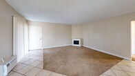Located at 16818 Downey Ave in Paramount, CA, this single-story, 3-bedroom, 2-bathroom home offers a well-organized and functional layout. The living room serves as the heart of the home, featuring a white corner fireplace, neutral beige walls, a textured ceiling, and a combination of tile and carpet flooring. Vertical blinds and a sliding glass door allow natural light to filter in, enhancing the open feel of the space. The kitchen is designed for efficiency, with white cabinetry, marble-style countertops, a gas range, built-in microwave, and large tile flooring. A window above the sink brings in additional natural light, keeping the kitchen bright. The three bedrooms are carpeted and finished with the same warm neutral tones found throughout the home. Each bedroom includes window coverings for privacy, and the primary bedroom features a sliding double-door closet for ample storage. The two bathrooms are clean and utilitarian — one includes a tub-shower combo with white surround and a single vanity, while the other features a stand-alone shower. A connecting hallway ties all rooms together in a straightforward, accessible layout, making this home a practical and comfortable living space.