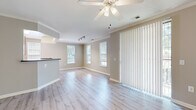 Located in the King Farm community of Rockville, MD, this well-appointed 3-bedroom, 2-bathroom single-floor home offers a comfortable and functional layout. The open living room is bright and welcoming, featuring light hardwood-style flooring, crown molding, a ceiling fan, and multiple windows that invite an abundance of natural light. A sliding glass door with vertical blinds opens to the outdoors, further enhancing the airy feel of the space. The kitchen is efficiently designed with light wood cabinetry, dark granite-style countertops, black appliances including a refrigerator and microwave, and a peninsula that provides additional prep space and casual seating. The three bedrooms are carpeted and comfortably sized, each offering good natural light through large windows. The spacious primary bedroom includes a walk-in closet outfitted with wire shelving and hanging rods for generous storage. Secondary bedrooms feature double-door closets. Both bathrooms are finished with tile flooring, warm wood vanity cabinets, and a tub-shower combination. Two hallways connect the rooms efficiently throughout the home, and a dedicated closet provides additional storage.