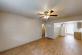 Located at 2615 El Toro Drive in Huntsville, Texas, this 2-bedroom, 1-bathroom home offers a functional and well-organized single-floor layout. The living room greets you at the entry with warm light wood-look flooring, a ceiling fan with integrated lighting, a textured ceiling, and a window that invites natural light. The space flows openly toward the kitchen, which is designed in a galley style with cream cabinetry, white countertops, a double-basin sink, and white appliances including a refrigerator and electric range. A window at the end of the kitchen provides additional natural light and ventilation. Both bedrooms feature plush carpeting, ceiling fans, and windows fitted with blinds, creating comfortable and private retreats. The primary bedroom offers a generous footprint with dedicated closet space. The bathroom is neatly appointed with a vanity, toilet, and a tub-shower combination accented by marble-patterned tile surround, lending a clean and polished feel. A connecting hallway ties the rooms together efficiently. Throughout the home, neutral tones, consistent finishes, and ample natural light contribute to a bright, cohesive, and easy-to-maintain living environment.