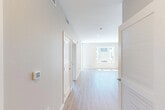 Located at 3580 Rambla Pl in Santa Clara, California, this thoughtfully designed one-bedroom, one-bathroom residence offers a clean, modern aesthetic throughout its efficiently laid-out single floor. Light hardwood-style flooring flows seamlessly across all rooms, complemented by crisp white trim and neutral warm-gray walls that create a bright, cohesive atmosphere.

The open-concept kitchen and living area serves as the heart of the home. The kitchen is outfitted with contemporary flat-front cabinetry in a light wood finish, a white subway tile backsplash, stainless steel appliances including a gas range, built-in microwave, French door refrigerator, and dishwasher, as well as an island with a built-in sink. Large windows flood the living area with natural light and offer views of the surrounding community.

The bedroom is a well-proportioned retreat featuring a large window with outdoor views and direct access to a private balcony, providing additional natural light and a seamless indoor-outdoor connection. A dedicated closet and hallway storage add practical convenience.

The bathroom is cleanly finished with a shower-tub combination, toilet, and hardwood-style flooring that ties into the rest of the home. Two hallways connect the spaces efficiently, and a smart thermostat is installed for modern climate control.