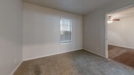 Located at 7414 E Grand Ave in Dallas, TX, this efficiently designed one-bedroom, one-bathroom unit offers a well-organized single-floor layout. The open-concept living, dining, and kitchen area serves as the heart of the home, where dark hardwood-style flooring, neutral walls, and a ceiling fan with light fixture create a bright and comfortable atmosphere. French doors lead to a private patio, allowing natural light to flow into the living space.

The kitchen is thoughtfully appointed with granite countertops, a peninsula with an undermount sink, subway tile backsplash, gray shaker-style cabinetry, and stainless steel appliances including a refrigerator, range, and over-the-range microwave.

The bedroom is carpeted for warmth and comfort, featuring a window with blinds that brings in natural light. Two closets provide ample storage throughout the unit. The bathroom includes a granite-topped vanity, a tub/shower combination, and textured walls for a clean, functional finish.

A dedicated laundry area houses a full-size side-by-side washer and dryer, adding everyday convenience. This unit combines practical amenities with a straightforward layout ideal for comfortable Dallas living.